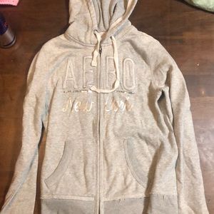 Zip up sweatshirt with gray and silver writing